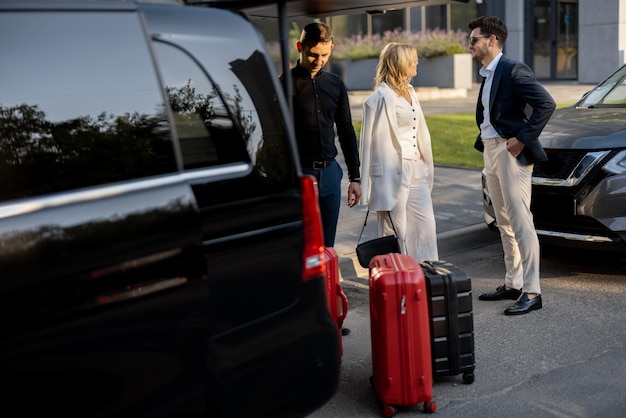 Newark Airport (EWR) 2 business couple near minivan taxi with suitcases chauffeur 506452 23521